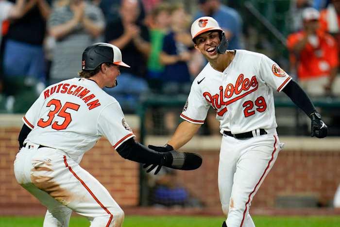 Baltimore Orioles’ Ramon Urias (29) is greeted near home plate by Adley Rutschman (35) after Urias’ two-run home run off Tampa Bay Rays relief pitcher Colin Poche scored both of them during the eighth inning of a baseball game, Tuesday, July 26, 2022, in Baltimore. The Orioles won 5-3.